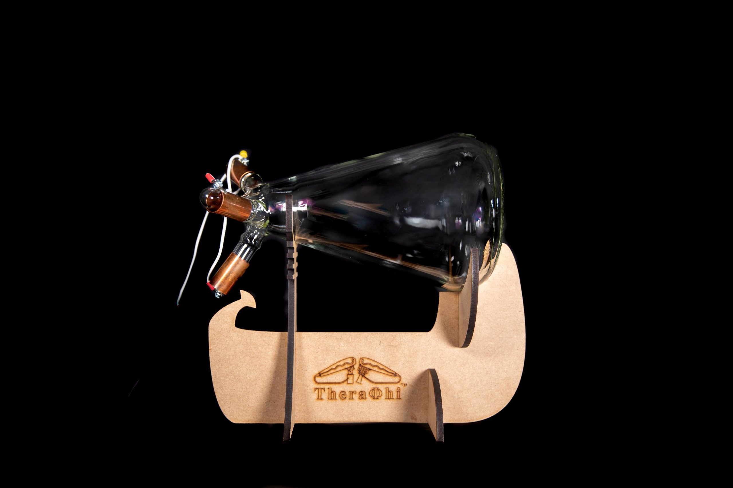 Theraphi glass bulb on the wooden stand on a black background