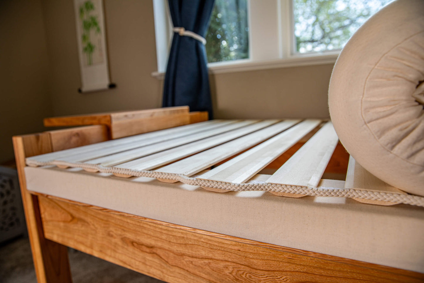 theraphi bed in front of a window. pulling back the matttress to show the bed frame underneath