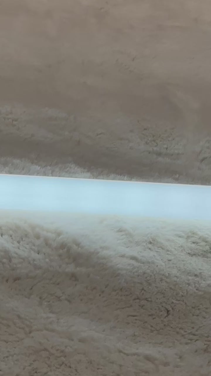 video showing the fluorescent tube being lit up on a bed between the Theraphi bulbs